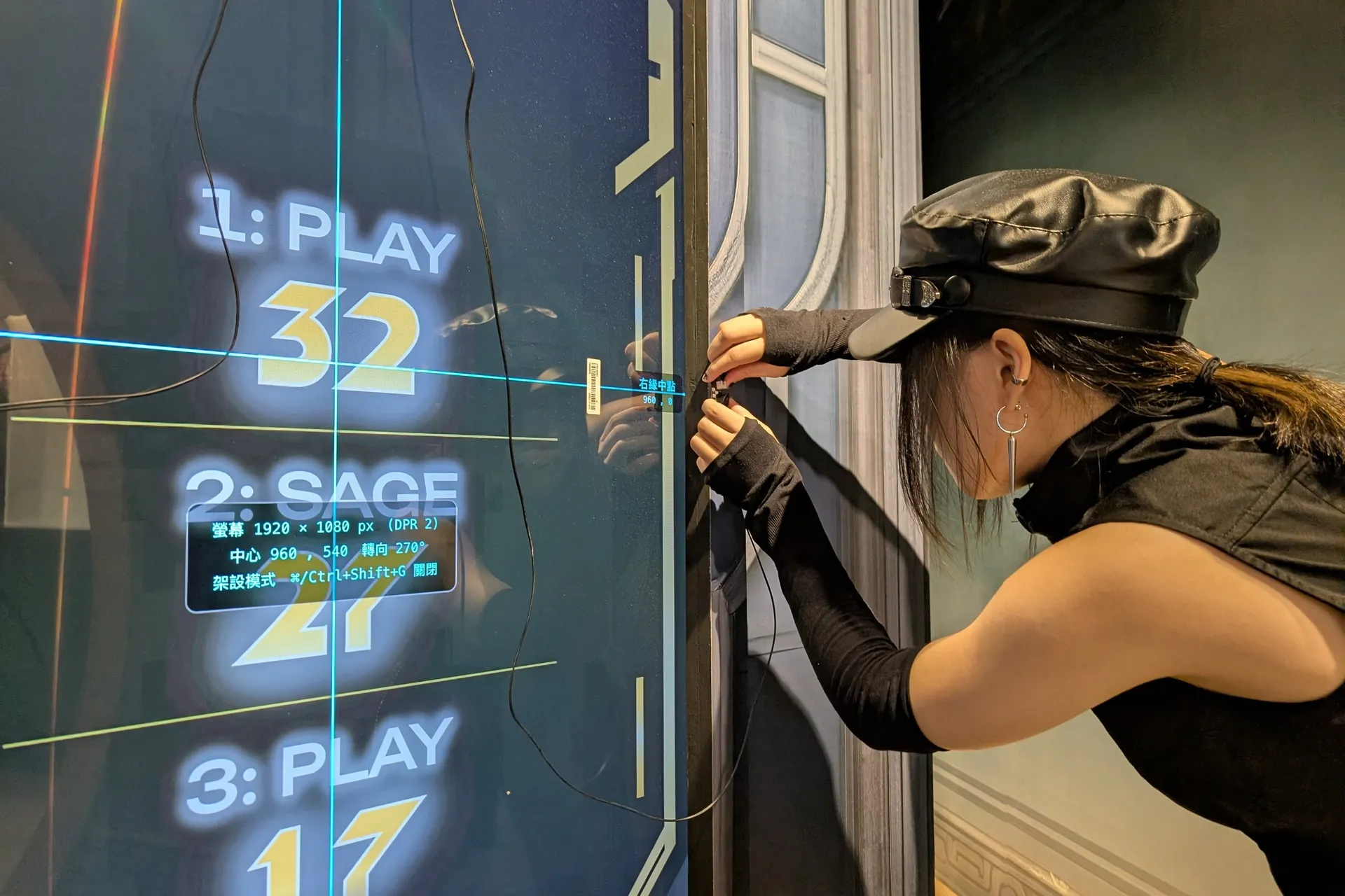 A crew member fits an infrared calibration point at the edge of the screen, at a position marked by the setup mode