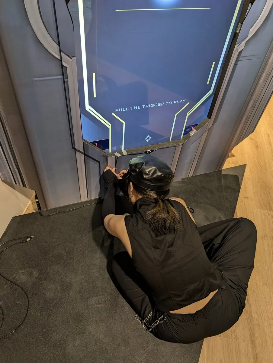 A crew member crouches under the screen to fit the infrared calibration point at its bottom edge