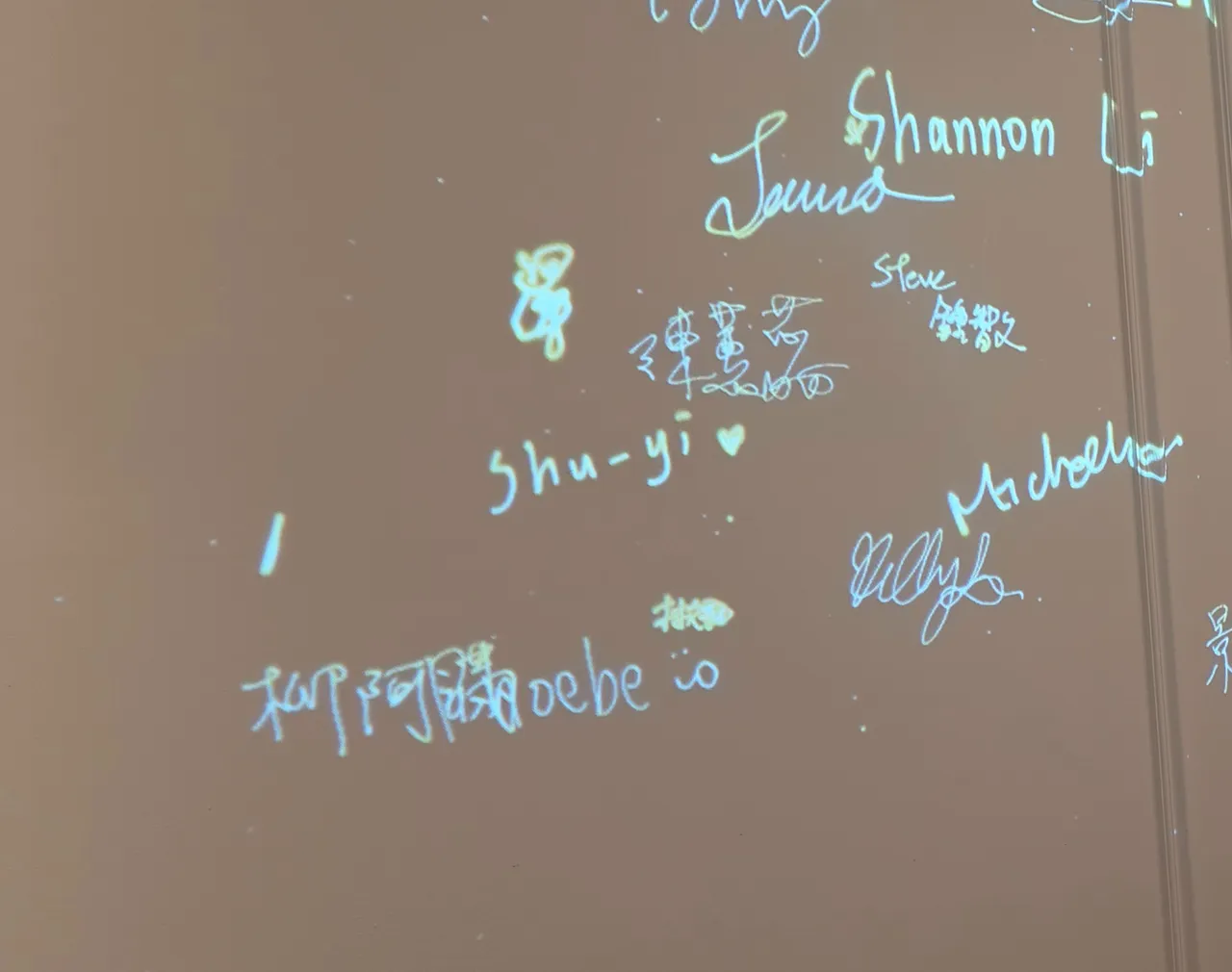 Guests’ signatures projected on the wall, seen up close